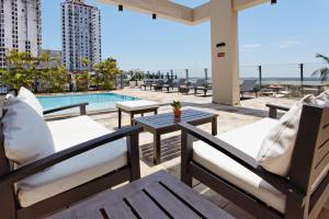a patio with chairs and a table and a pool at Crowne Plaza Asunción by IHG in Asunción