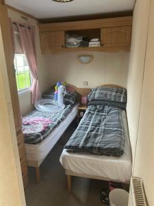 a small room with two beds in a trailer at Nickys happy place in Greencastle