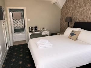 a hotel room with a bed and a window at Holland Hotel in Llanfachraeth