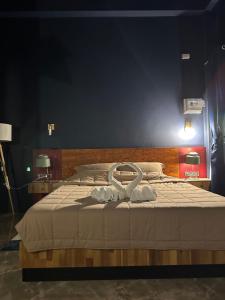 a bedroom with a bed with a white towel on it at Boonfarm&homestay in Ban Nop Hak