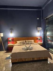 a bedroom with a bed with two slippers on it at Boonfarm&homestay in Ban Nop Hak