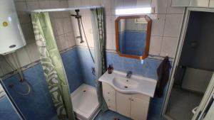 a bathroom with a sink and a shower at Good Hostel Prishtina in Prishtinë