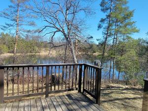 a wooden deck with a view of a lake at Secluded Chalet in Harrison