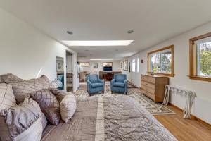 a living room with a couch and two blue chairs at Walkable, Dog Friendly! Friday Harbor Stay w/ Deck in Friday Harbor