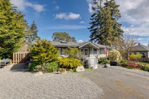 a house with a gravel driveway in front of it at Walkable, Dog Friendly! Friday Harbor Stay w/ Deck in Friday Harbor