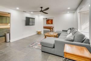 a living room with a couch and a table at Deck + Pool Table! Walk to Dtwn Jensen Beach in Jensen Beach