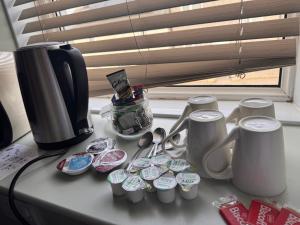 a counter with cups and spoons on a table at Holland Hotel in Llanfachraeth