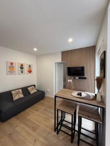 a living room with a table and a couch at Évasion cosy, proche de Paris in Argenteuil