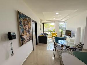 a living room and dining room with a painting on the wall at Nice and Modern Apartment, Parking in SamborondÃ³n