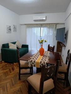 a living room with a table and a green couch at alma in Buenos Aires