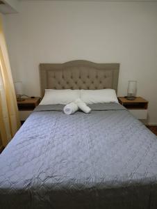 a bed with two rolled up towels on it at alma in Buenos Aires
