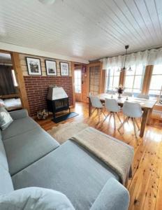 a living room with a couch and a table with chairs at Villa Safari in Perniö +49 photos