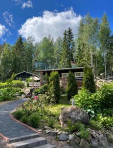 a house with a garden in front of it at Villa Safari in Perniö