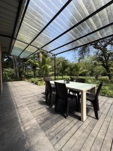 a patio with a table and chairs under a pergola at Rio Olón ecolodge in Olón