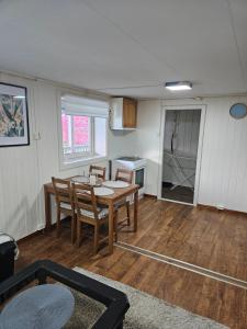 a kitchen and dining room with a table and chairs at Søvikhus in Haram