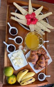 a tray of food with cheese bread and other foods at Chez L'Avocatier in Sainte Marie