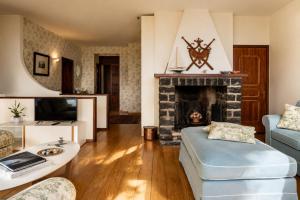 a living room with a fireplace and a couch at Villa Le Rose, Menaggio in Menaggio