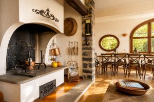a kitchen and dining room with an oven and a table at Villa Le Rose, Menaggio in Menaggio