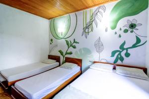two beds in a room with a mural on the wall at Sítio com Piscina Aquecida 7 Quartos com ar condicionado próximo de São Paulo in Juquitiba +23 photos