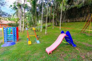 a playground with colorful play equipment in the grass at Sítio com Piscina Aquecida 7 Quartos com ar condicionado próximo de São Paulo in Juquitiba