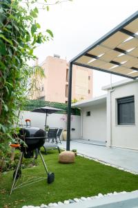 a barbecue grill sitting on top of a yard at Latitude 37 Luxe in Kalamata