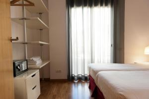 Posteľ alebo postele v izbe v ubytovaní MH Apartments Gracia