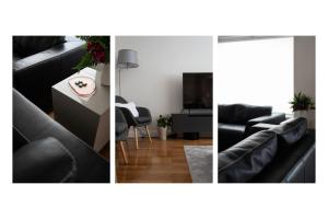a living room with a black couch and a table at Oly modern apartment in Katerini