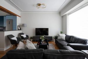 a living room with a couch and a tv at Oly modern apartment in Katerini