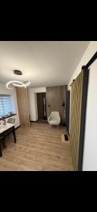 a living room with a table and a chair at Apartament z Balią in Świeradów-Zdrój