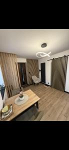 a living room with a table and a couch at Apartament z Balią in Świeradów-Zdrój