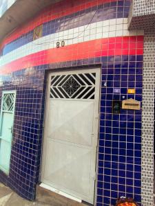 a tiled wall with a door on a building at Studio Premium - ap 05 in Diadema