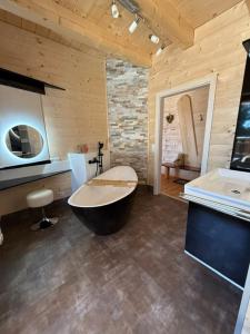 a large bathroom with a tub and a sink at Wellness Chalet Zirbitz in Lavantegg +19 photos