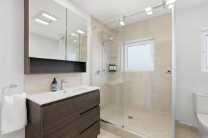 a bathroom with a sink and a shower at Designer Stay with River Views) in Sandy Bay +27 photos