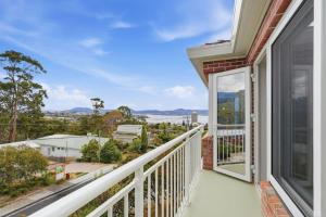 a balcony with a view of a city at Designer Stay with River Views) in Sandy Bay