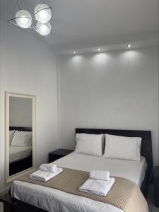 a bedroom with a bed with two towels on it at Armonia Maisonette in Pefkochori