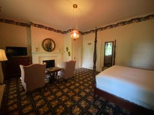 a bedroom with a bed and a fireplace at Beaumont Inn in Harrodsburg