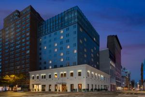 a tall blue building with a white building at Hyatt Union Square New York in New York