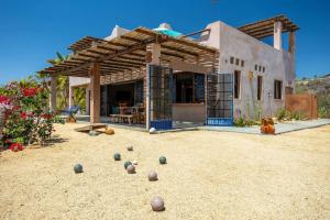 a bunch of balls on the ground in front of a house at 2BR with Stunning Ocean Views in Las Palmas