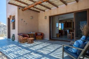 a patio with couches and a table and chairs at 2BR with Stunning Ocean Views in Las Palmas