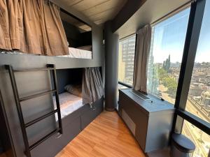 a room with two bunk beds and a window at MONS hostel in Buenos Aires