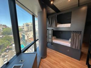 a room with bunk beds with a view of a city at MONS hostel in Buenos Aires