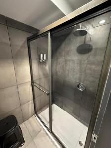 a shower with a glass door in a bathroom at MONS hostel in Buenos Aires