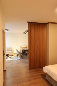 a bedroom with a door leading to a dining room at NUMA LIVING - Executive Suite in Kumanovo