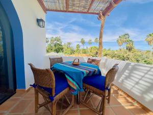 a table and chairs on the balcony of a house at Near Beach Casita With Firepit in Los Barriles