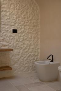 a bathroom with a bath tub and a sink at Casa Olivi in Ventotene