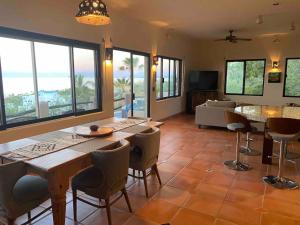 a living room with tables and chairs and a couch at Home With Private Pool Ocean and Mountain Views in Los Barriles