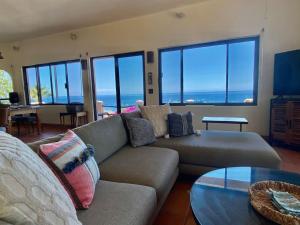 a living room with a couch and a table at Home With Private Pool Ocean and Mountain Views in Los Barriles