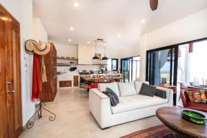 a living room with a white couch and a table at Montebello Pool House-3 BD in Los Barriles