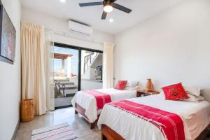 a bedroom with two beds and a balcony at Montebello Pool House-3 BD in Los Barriles +60 photos