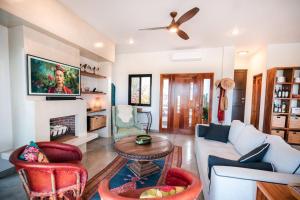 a living room with a couch and a tv at Montebello Pool House-3 BD in Los Barriles